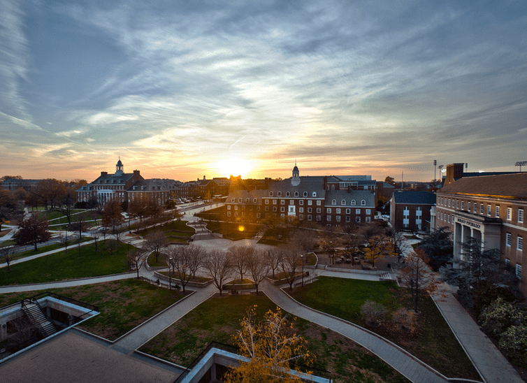 Hornbake plaza at sunset after a colorful fall day. the clouds are like dry brush strokes criss-crossing the fading sky
